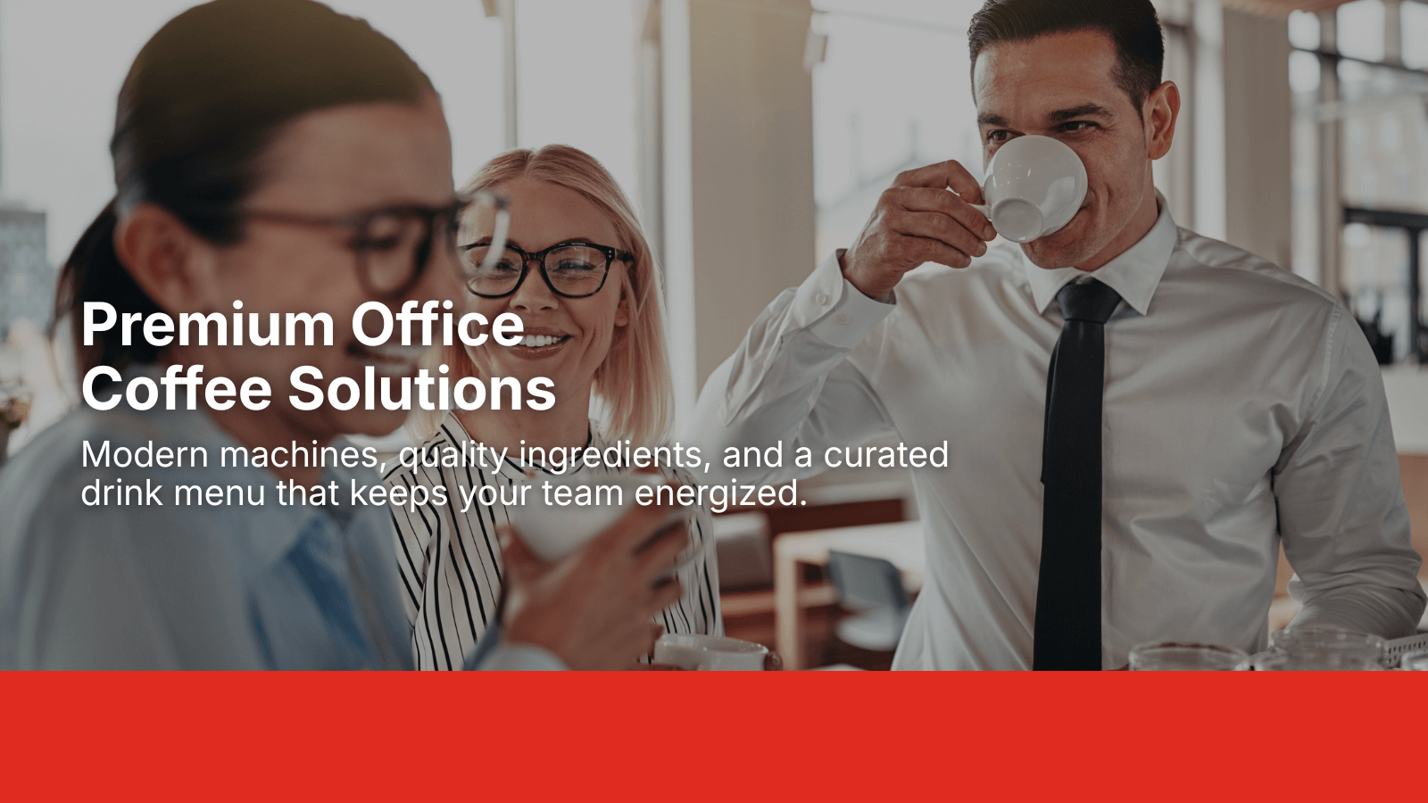 Group of coworkers smiling and drinking coffee in a modern office setting, promoting Enroute Vending workplace coffee solutions.