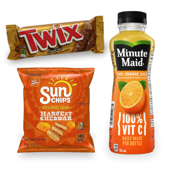 Assorted vending snacks including a Twix bar, a bag of Sun Chips Harvest Cheddar, and a bottle of Minute Maid orange juice