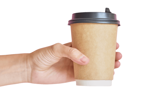 A close up of a hand holding a disposable coffee cup with a black lid against a transparent background.